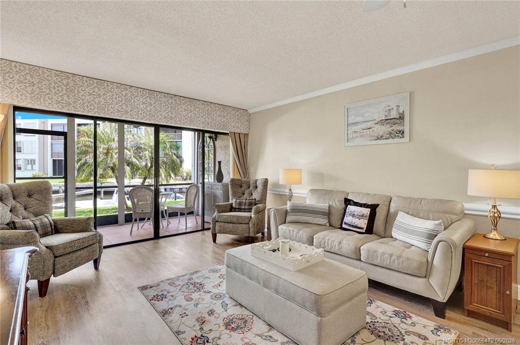 1950 Southwest Palm City Road, Unit 2102 Stuart, FL 34994 - Photo 21 of 55 a living room with furniture and a large window with balcony view