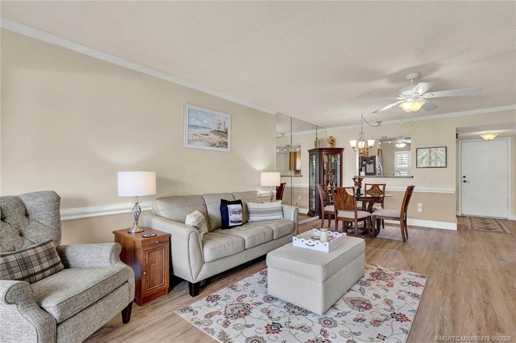 1950 Southwest Palm City Road, Unit 2102 Stuart, FL 34994 - Photo 23 of 55 a living room with furniture and wooden floor