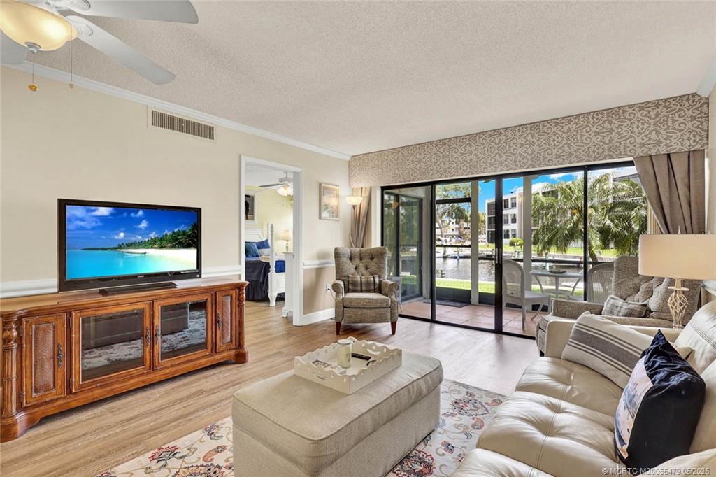 1950 Southwest Palm City Road, Unit 2102 Stuart, FL 34994 - Photo 24 of 55 a living room with furniture and a flat screen tv