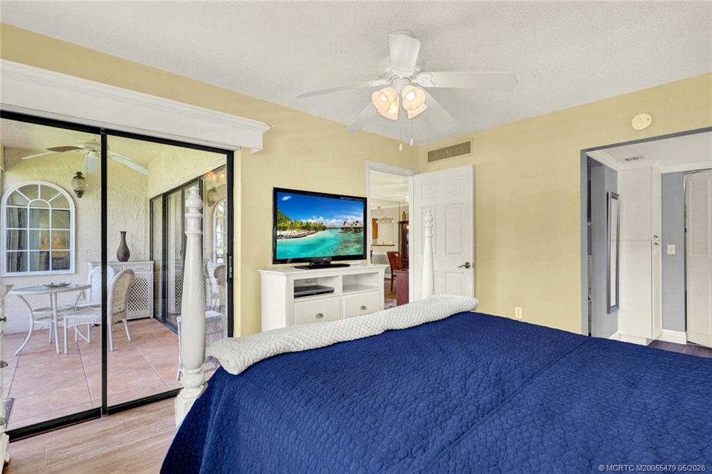 1950 Southwest Palm City Road, Unit 2102 Stuart, FL 34994 - Photo 28 of 55 a view of a livingroom with wooden floor and a flat screen tv