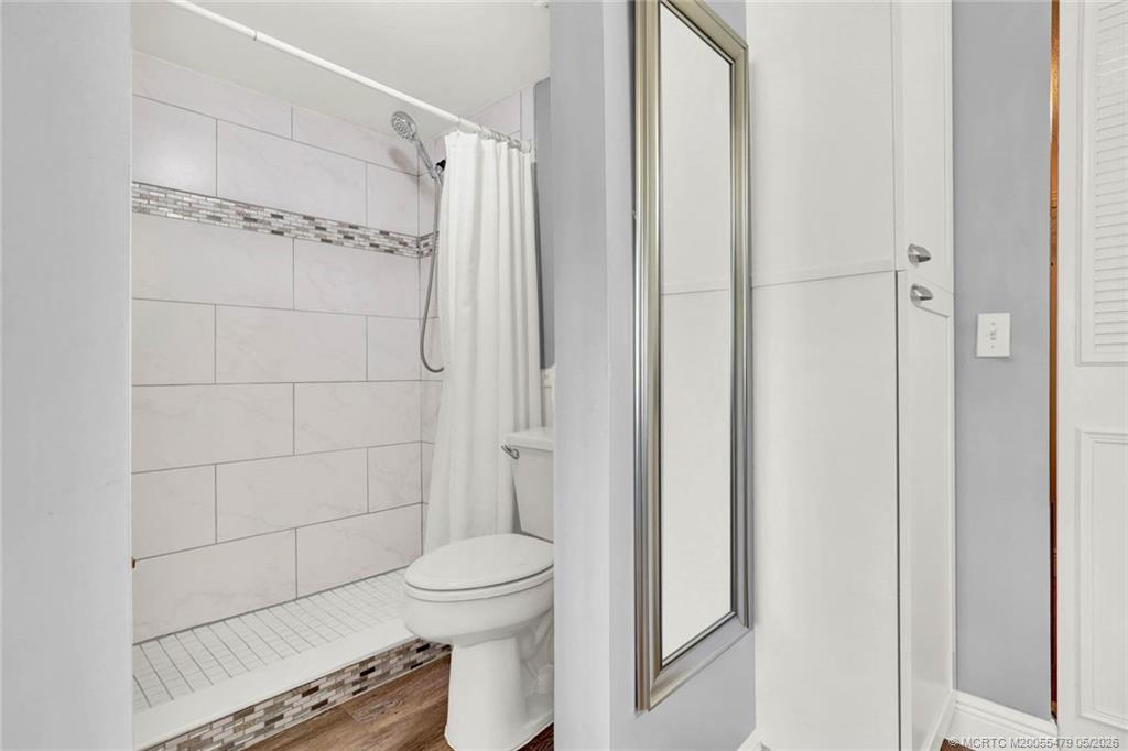 1950 Southwest Palm City Road, Unit 2102 Stuart, FL 34994 - Photo 30 of 55 a bathroom with a shower and a toilet