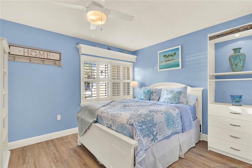 1950 Southwest Palm City Road, Unit 2102 Stuart, FL 34994 - Photo 32 of 55 a bedroom with a bed and window
