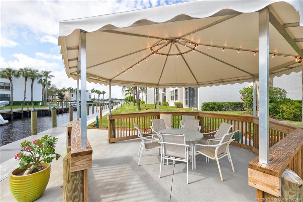 1950 Southwest Palm City Road, Unit 2102 Stuart, FL 34994 - Photo 55 of 55 a view of a chair and table in the patio