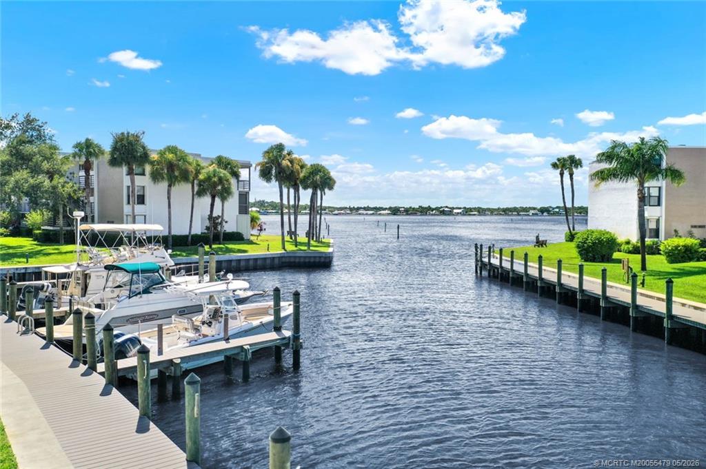 1950 Southwest Palm City Road, Unit 2102 Stuart, FL 34994 - Photo 6 of 55 a view of a lake with a table and chairs