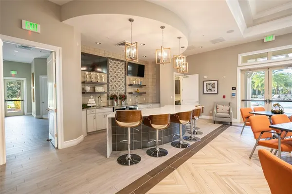 a dining room with wooden floor and a floor to ceiling window