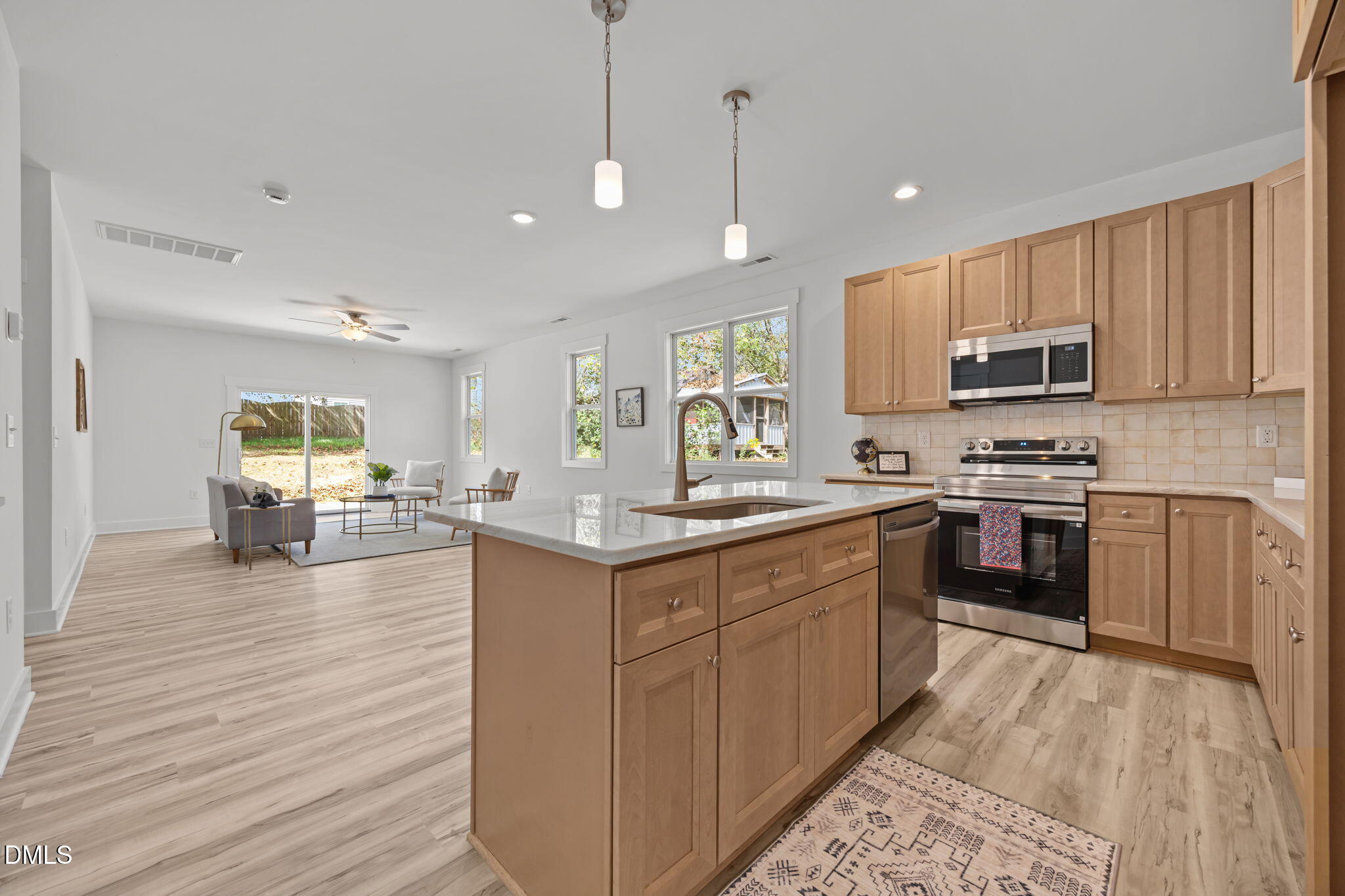 144 Howard Harris Road Franklinton, NC 27525 - Photo 2 of 21 a kitchen with stainless steel appliances kitchen island granite countertop a stove a sink and a microwave