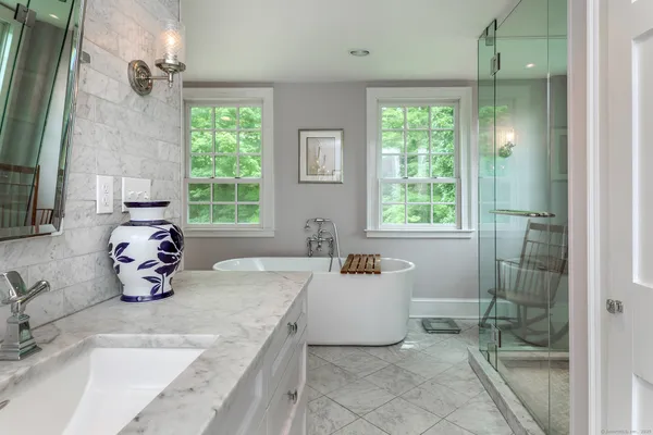 a kitchen with a sink a window and chairs