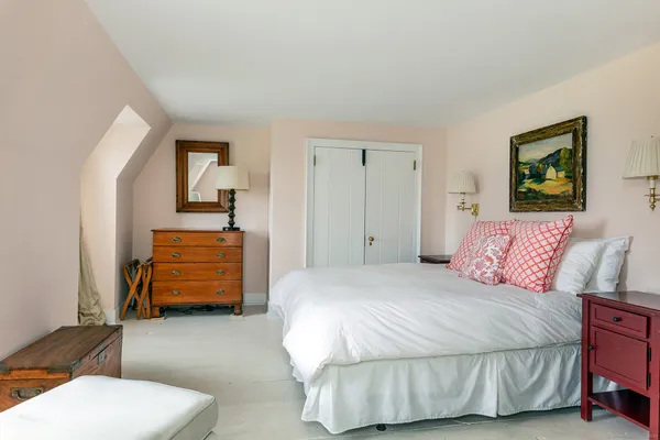 a bedroom with a bed and a couch