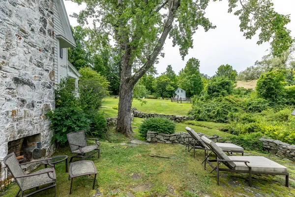 a view of a garden with lawn chairs