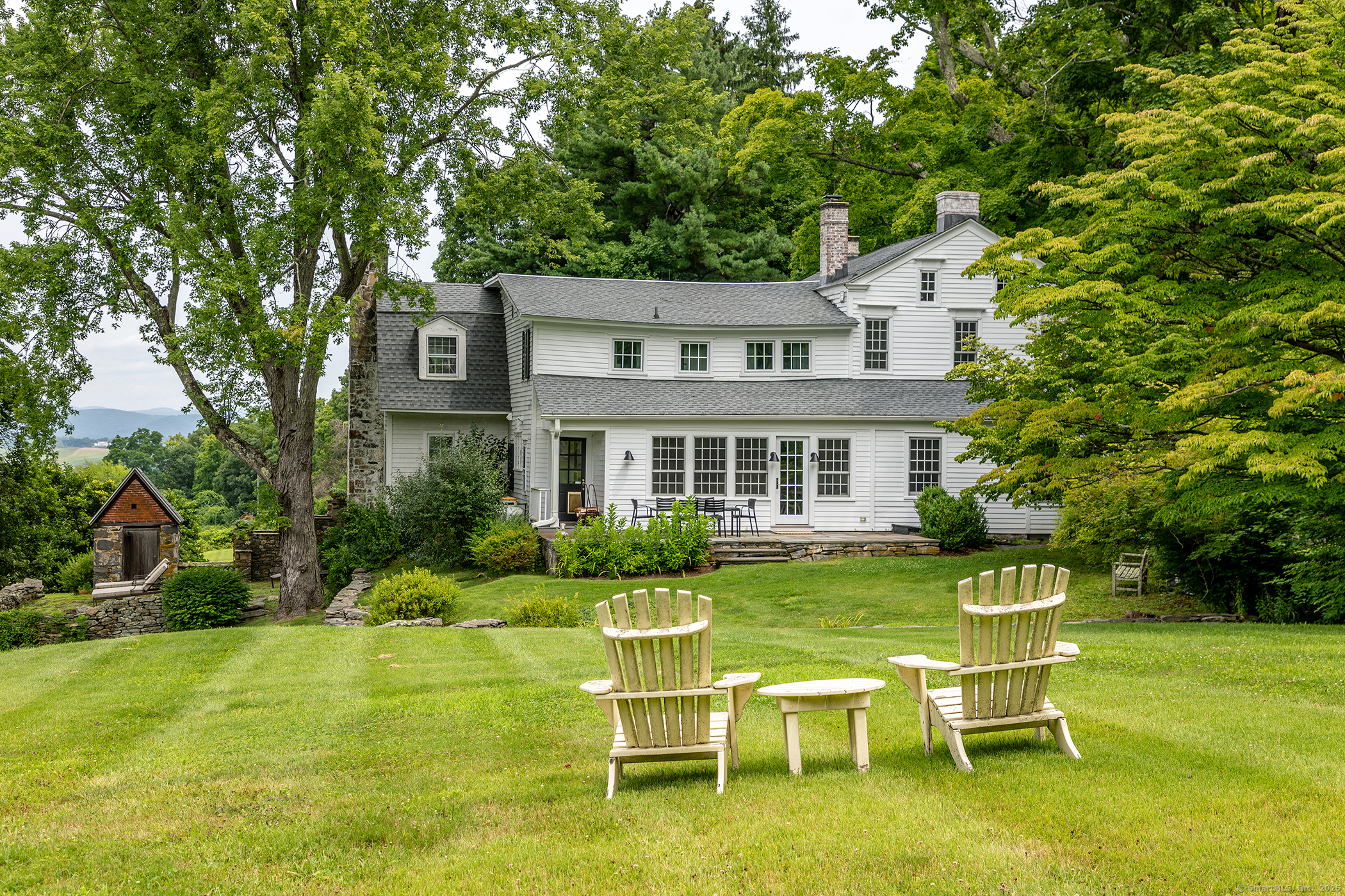 119 Knibloe Hill Road Sharon, CT 06069 - Photo 28 of 30 a front view of a house with a yard table and chairs