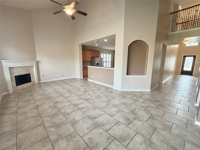 a view of an empty room with a fireplace and a window
