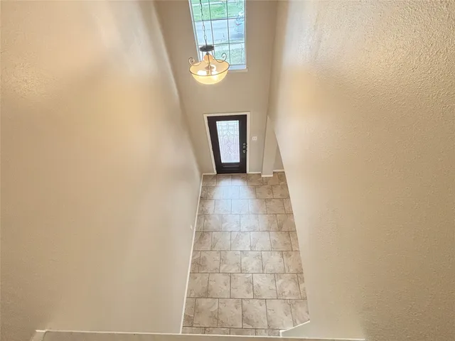 a view of a livingroom with wooden floor and stairs