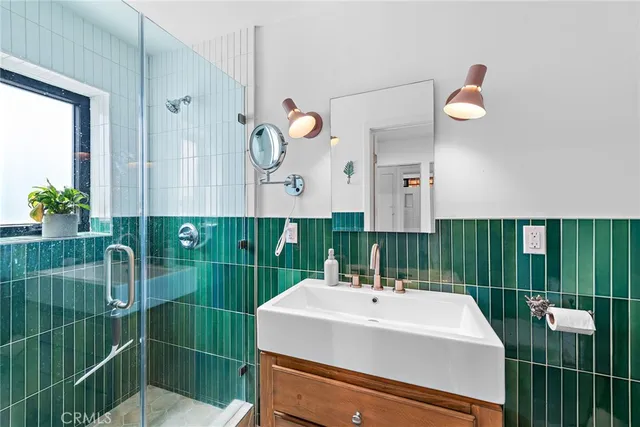 a bathroom with a sink mirror and vanity