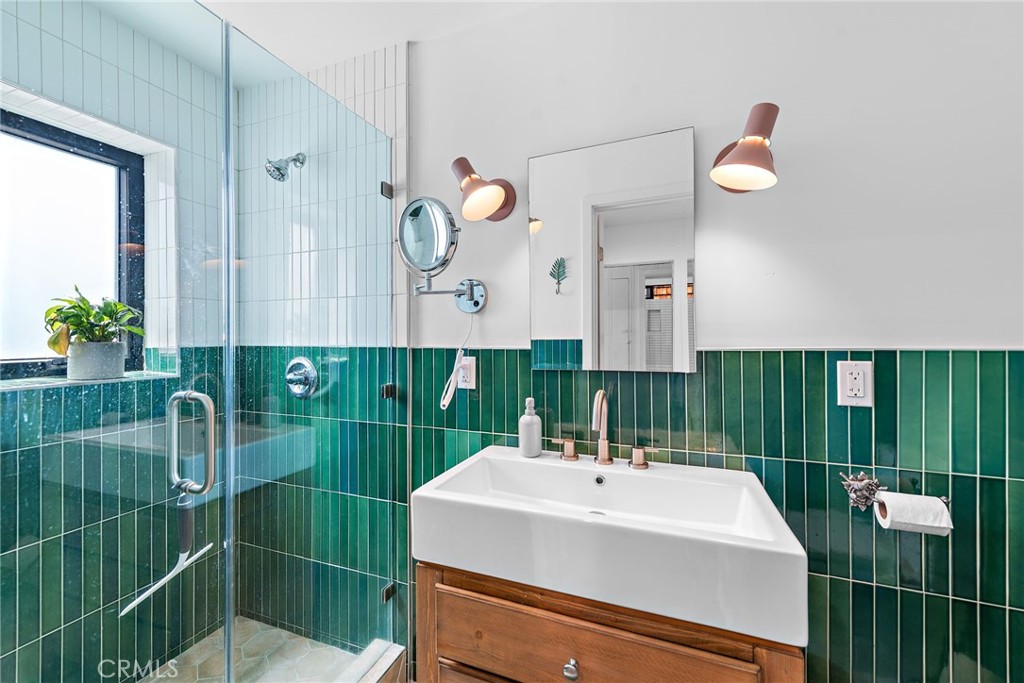 450 Ruby Street, Unit LOWR Laguna Beach, CA 92651 - Photo 11 of 22 a bathroom with a sink mirror and vanity