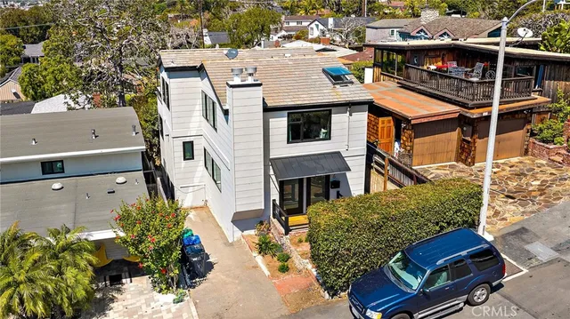 an aerial view of a house with a yard
