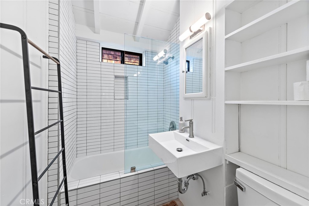 450 Ruby Street, Unit LOWR Laguna Beach, CA 92651 - Photo 8 of 22 a bathroom with a sink a toilet and shower