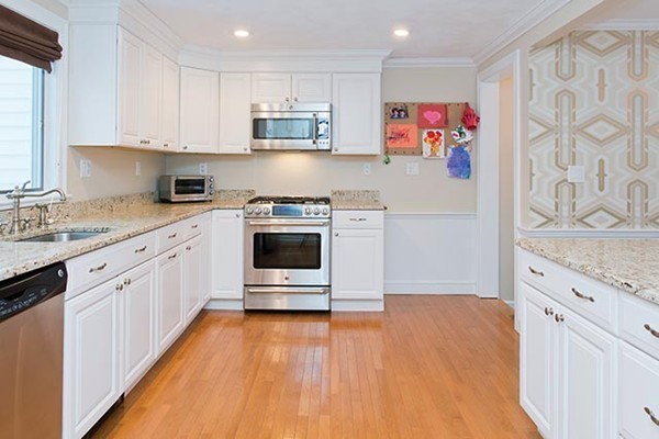 17 Hagen Road Newton, MA 02459 - Photo 5 of 10 a kitchen with stainless steel appliances granite countertop a stove a sink and a refrigerator