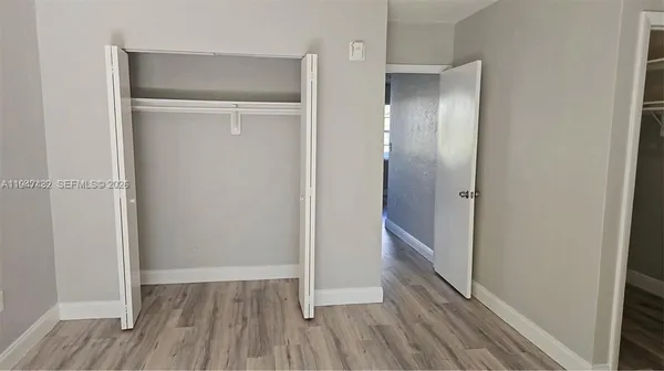 a view of hallway with wooden floor