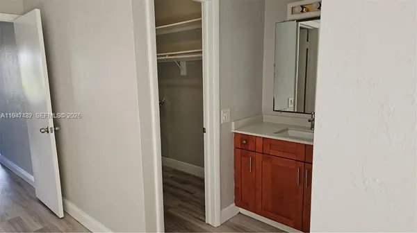 a view of hallway with wooden floor