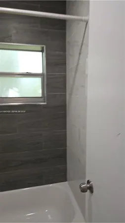 a bathroom with a toilet and a bathtub