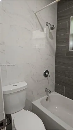 a bathroom with a sink a toilet and bathtub