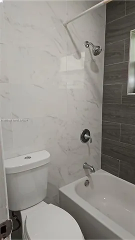 a bathroom with a sink a toilet and bathtub