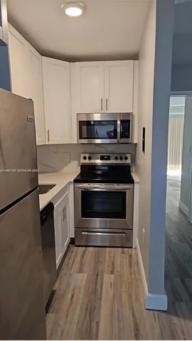 a kitchen with a stove and a refrigerator