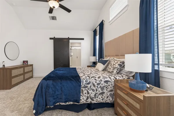 a bedroom with a bed and window