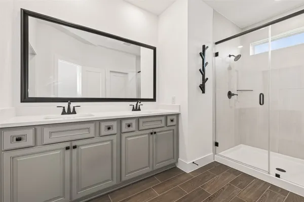 a bathroom with a double vanity sink mirror and double