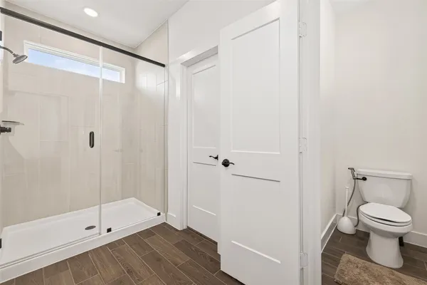a bathroom with a toilet and a shower