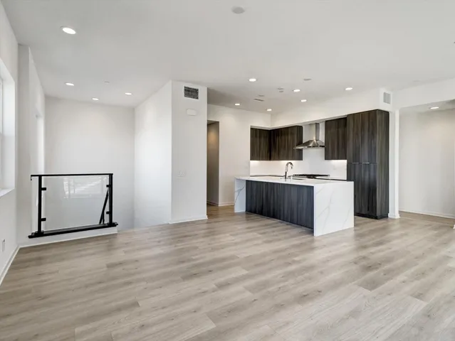 a kitchen with stainless steel appliances granite countertop a refrigerator and a stove top oven