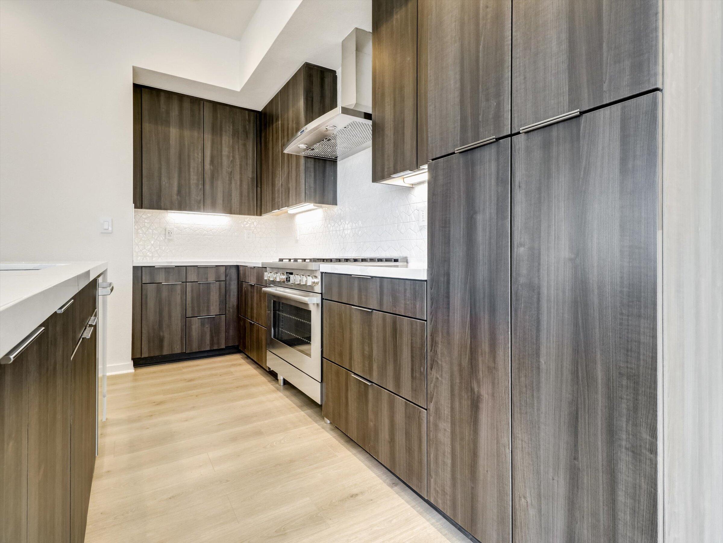 718 Obsidian Loop East, Unit 73 Palm Springs, CA 92264 - Photo 14 of 49 a kitchen with stainless steel appliances granite countertop a stove a sink and a refrigerator