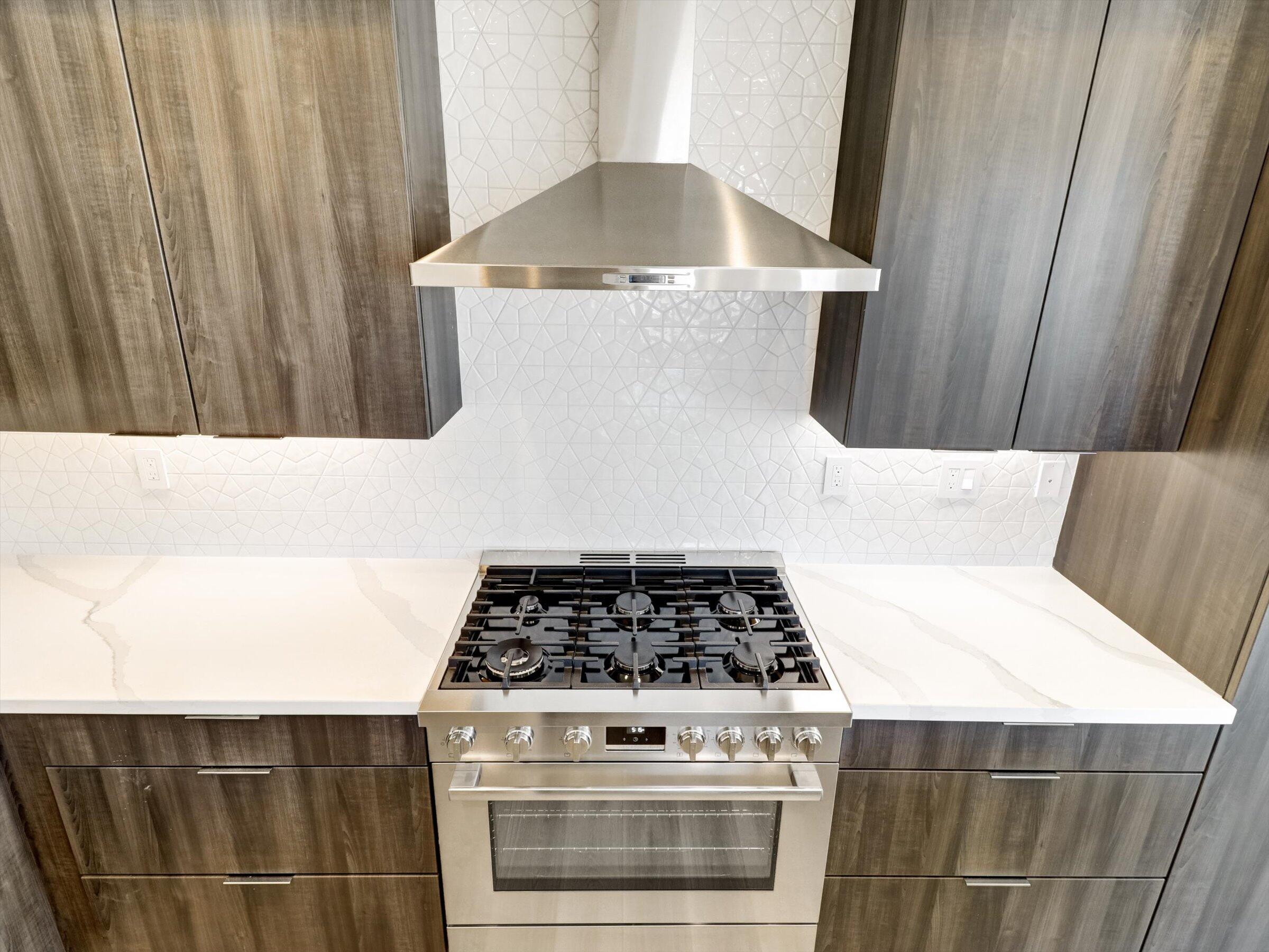 718 Obsidian Loop East, Unit 73 Palm Springs, CA 92264 - Photo 16 of 49 a kitchen with a stove and a cabinet