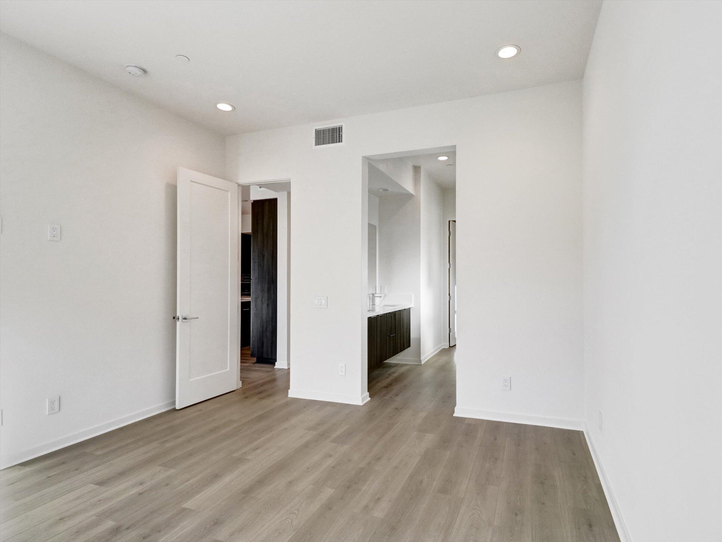 718 Obsidian Loop East, Unit 73 Palm Springs, CA 92264 - Photo 24 of 49 a view of an empty room with wooden floor and closet