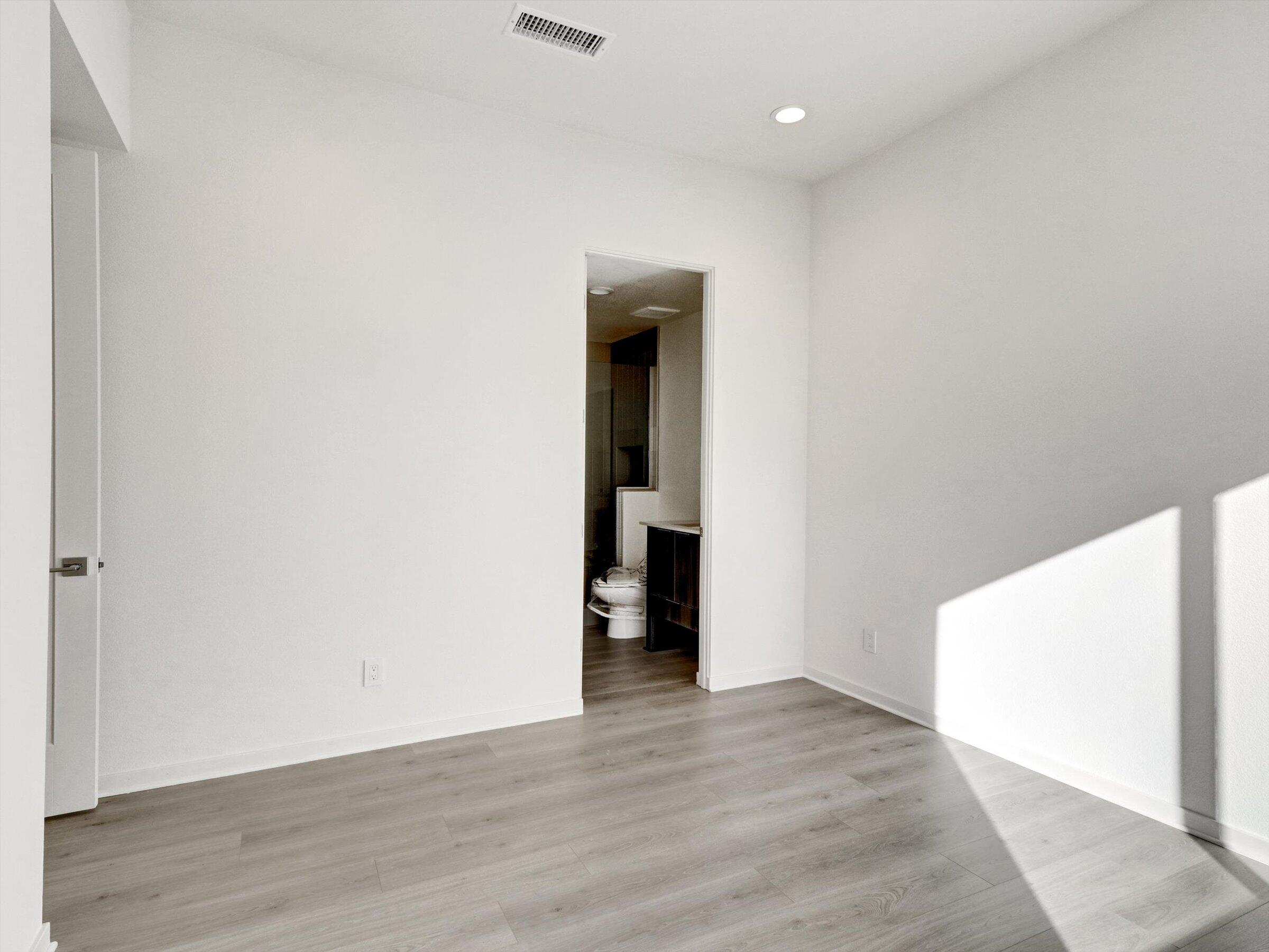718 Obsidian Loop East, Unit 73 Palm Springs, CA 92264 - Photo 29 of 49 a view of an empty room with wooden floor and closet