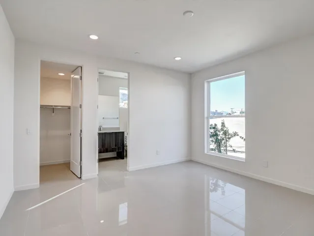 an empty room with windows and closet