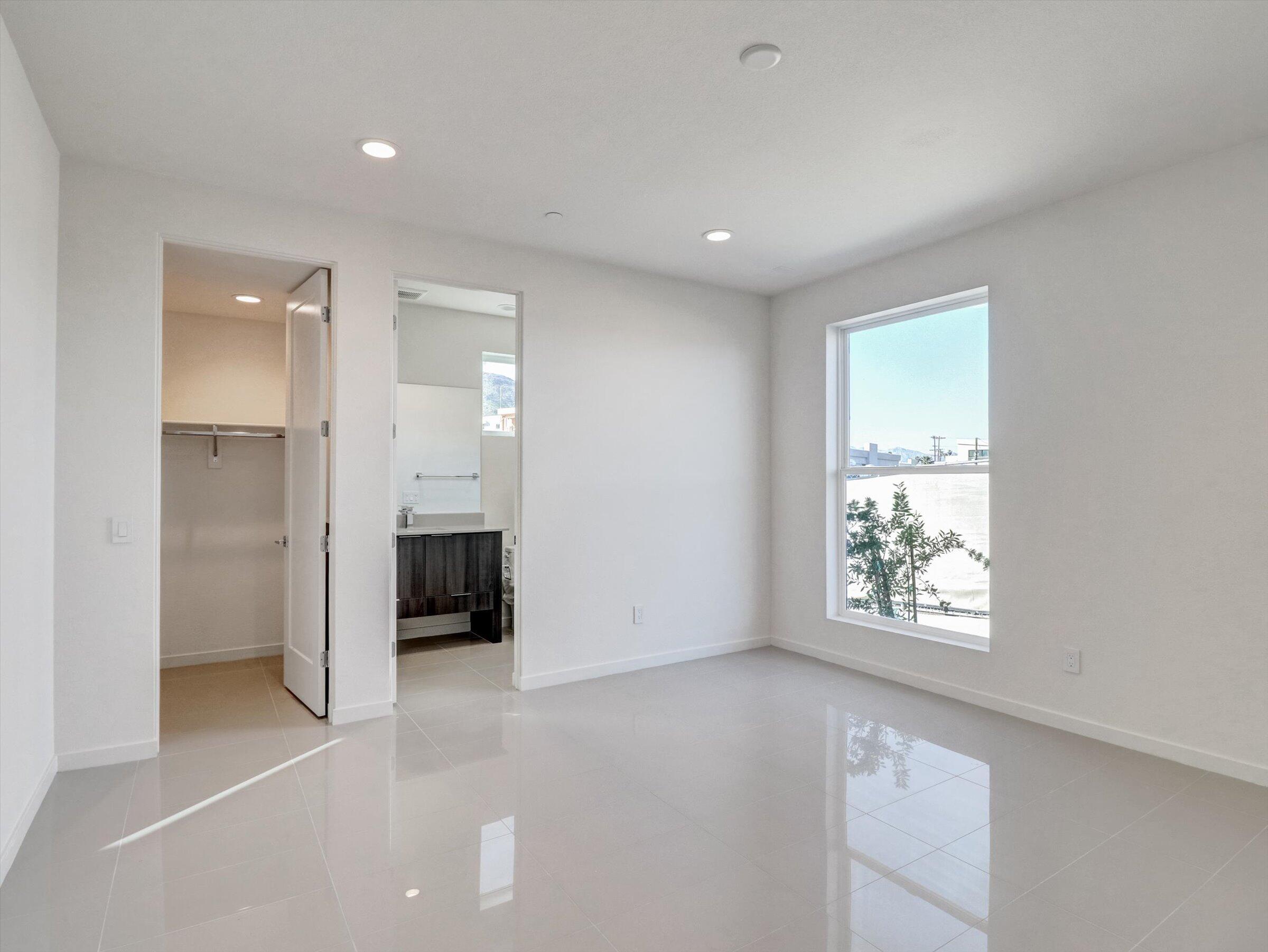 718 Obsidian Loop East, Unit 73 Palm Springs, CA 92264 - Photo 3 of 49 an empty room with windows and closet