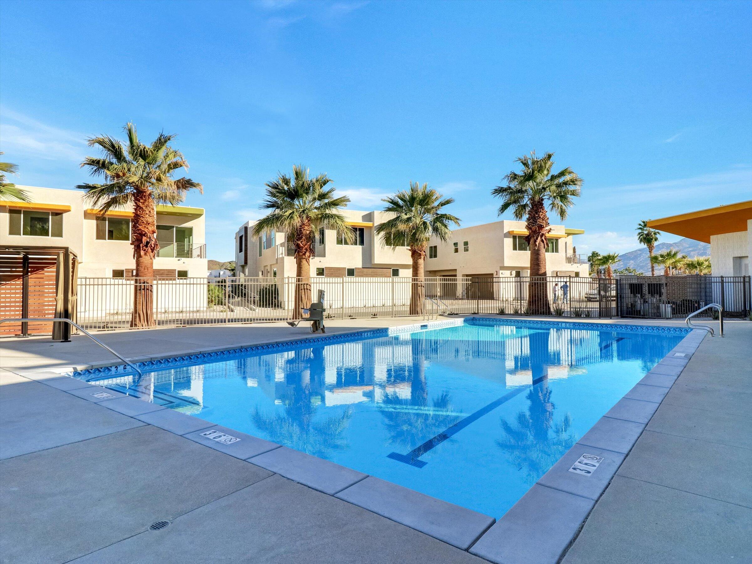 718 Obsidian Loop East, Unit 73 Palm Springs, CA 92264 - Photo 36 of 49 a view of a swimming pool with outdoor seating