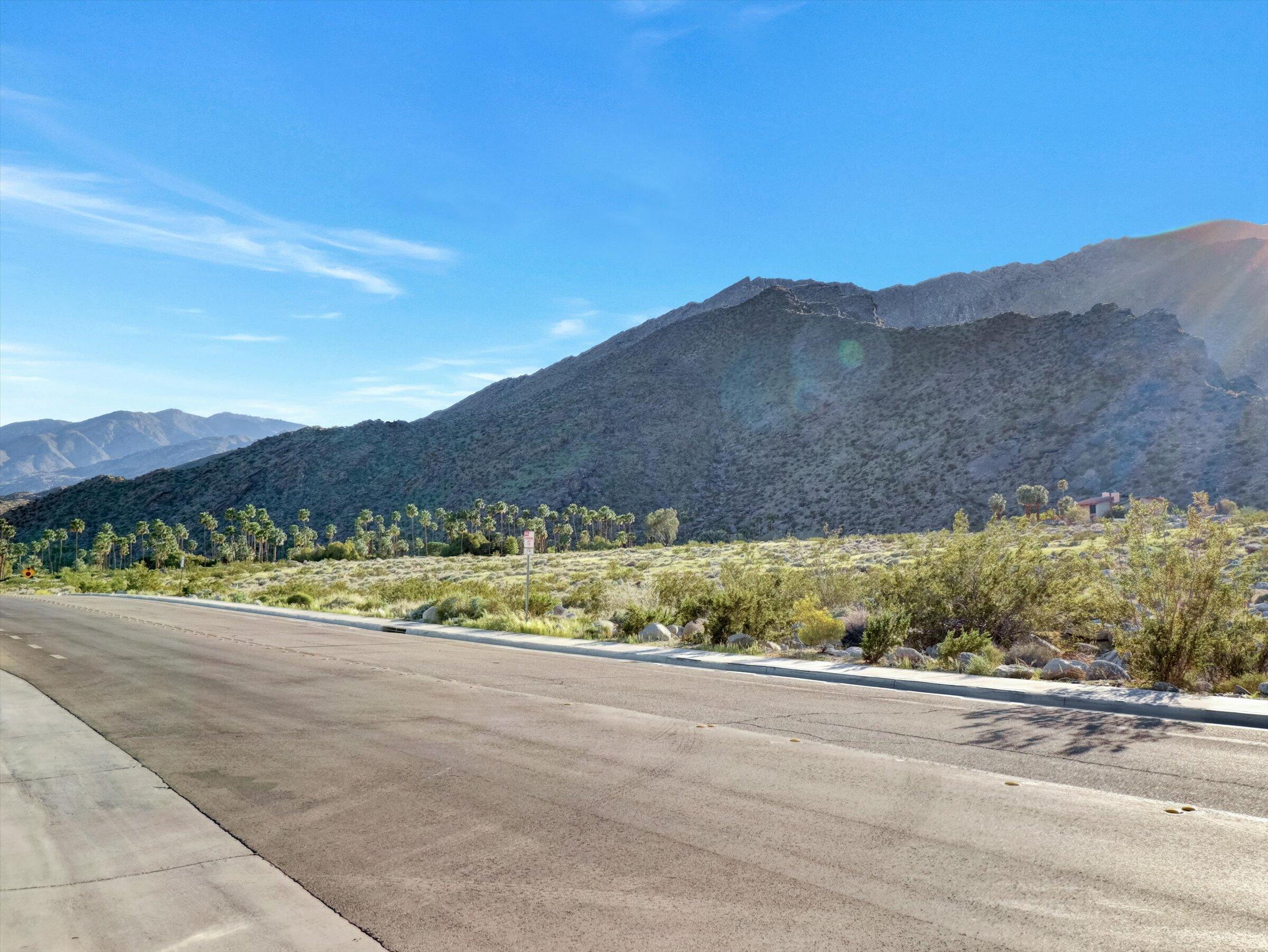 718 Obsidian Loop East, Unit 73 Palm Springs, CA 92264 - Photo 45 of 49 a view of a lush green hillside and houses