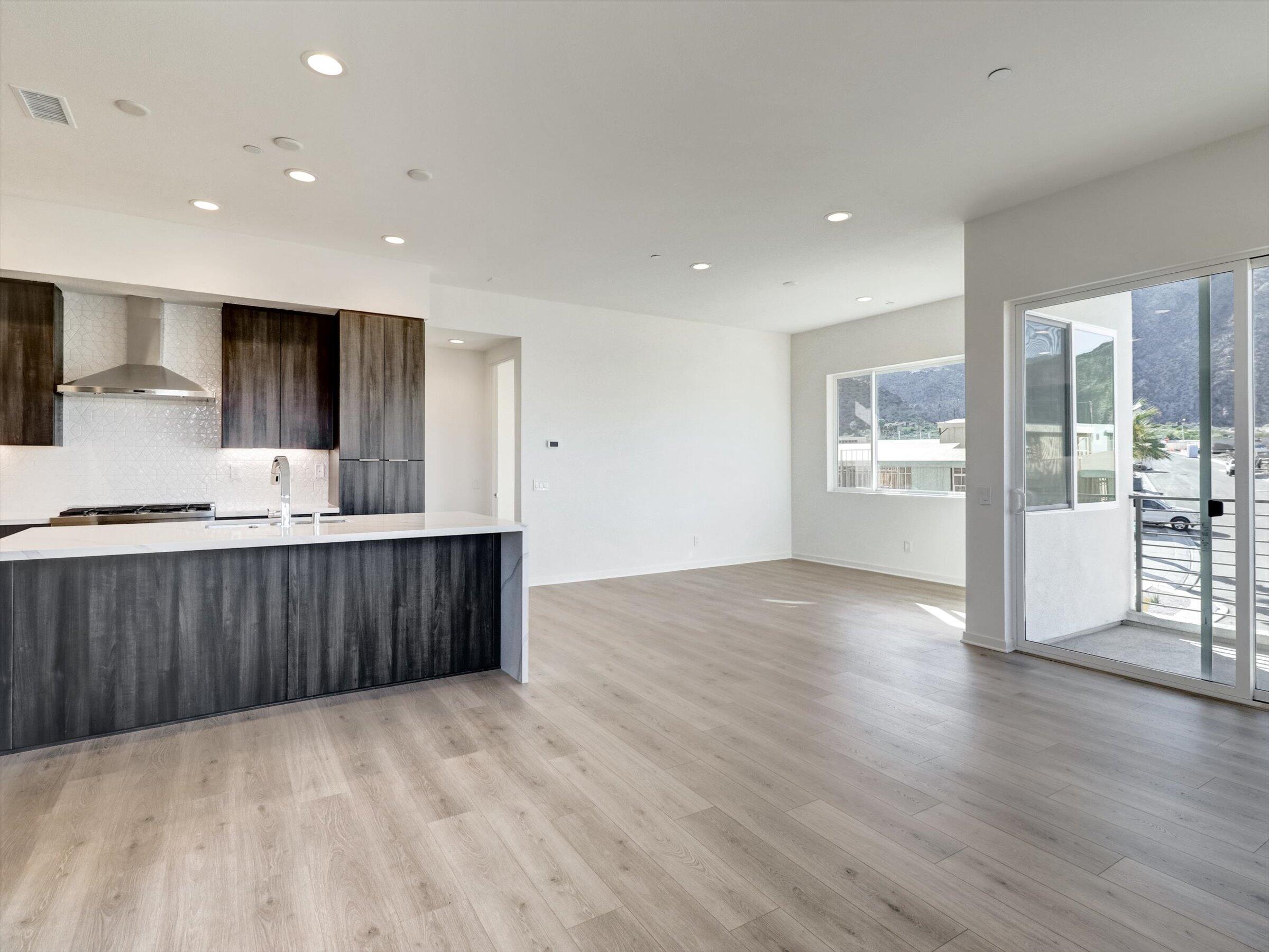 718 Obsidian Loop East, Unit 73 Palm Springs, CA 92264 - Photo 9 of 49 a view of kitchen with wooden floor and electronic appliances