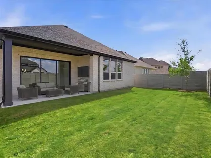 an aerial view of a swimming pool a yard and mountain view in back
