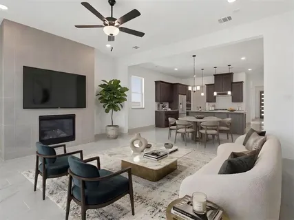 a living room with furniture a flat screen tv and a large window