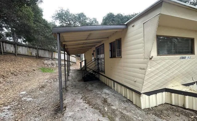 a view of a livingroom with wooden floor and a fireplace