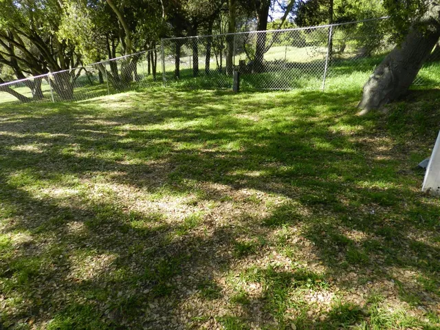 a living room with furniture mirror and a flat screen tv