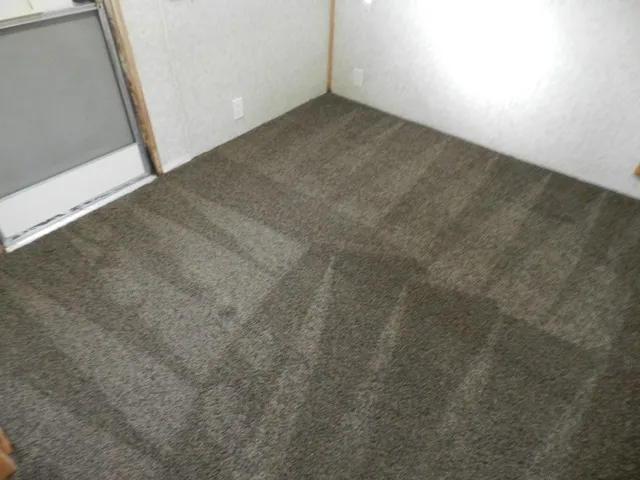 a bedroom with a bed and a mirror