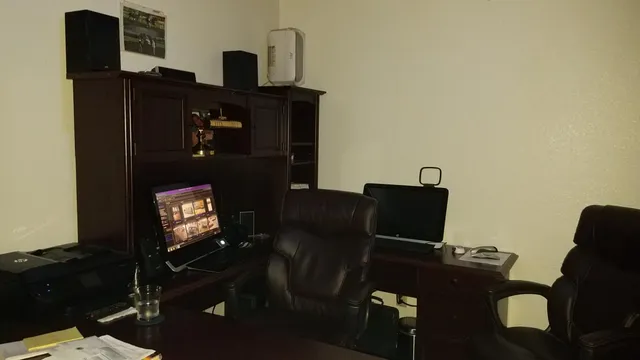 a view of an empty room with wooden floor and a porch