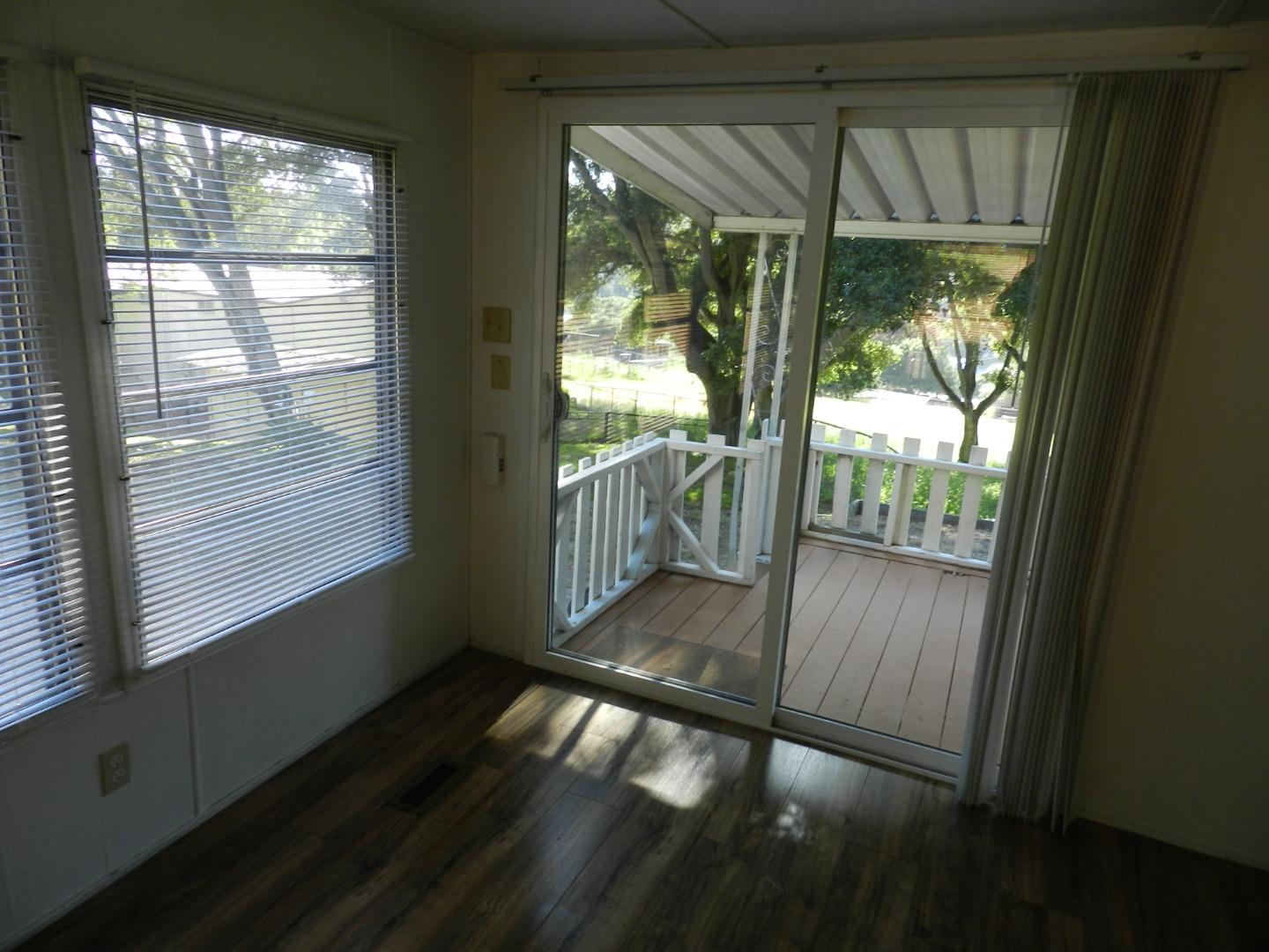 17653 Vierra Canyon Road Salinas, CA 93907 - Photo 83 of 100 a view of an empty room with wooden floor and a porch