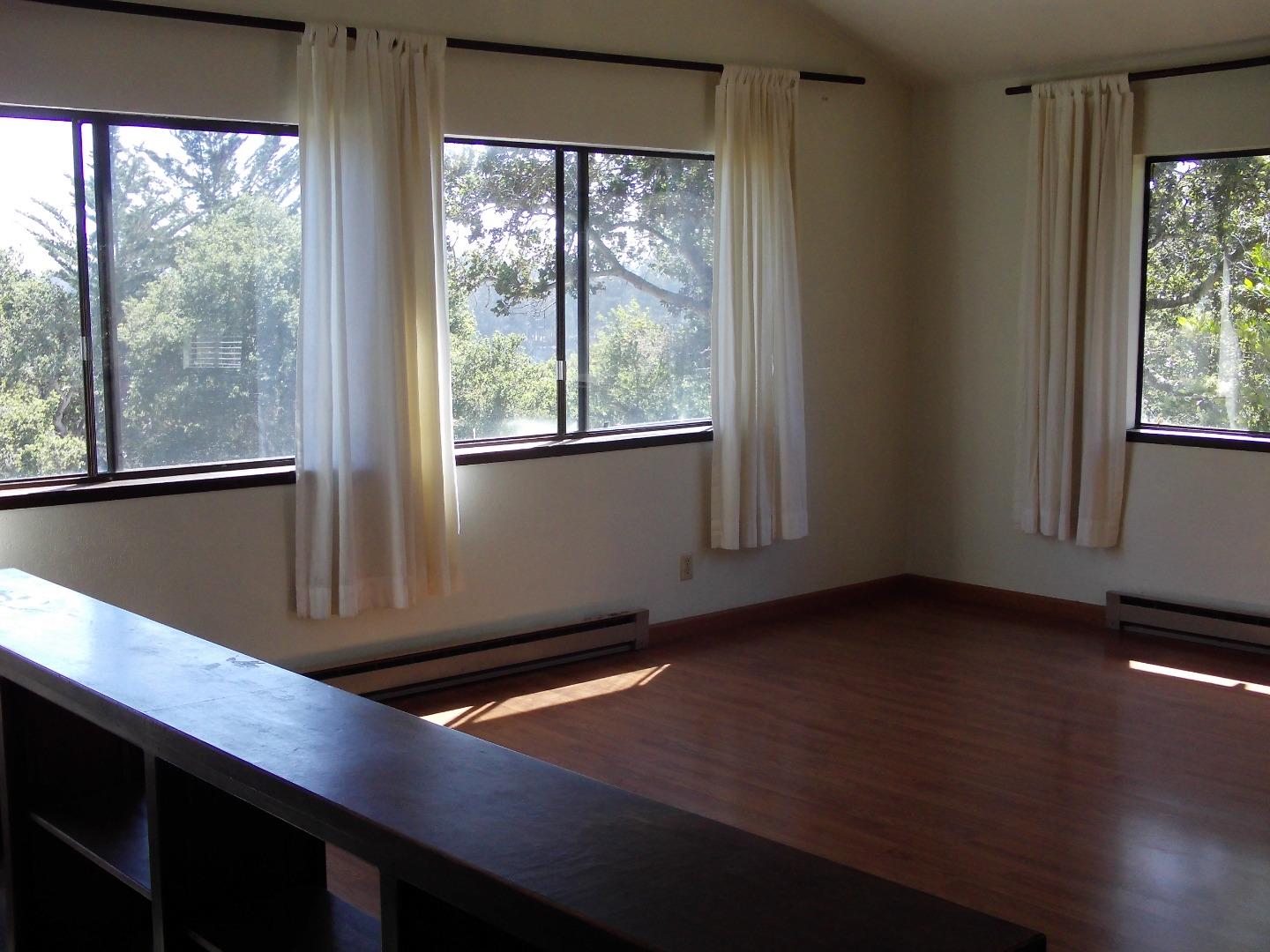17653 Vierra Canyon Road Salinas, CA 93907 - Photo 98 of 100 a view of an empty room with wooden floor and windows