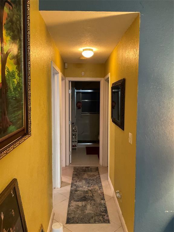 4770 Northwest 85th Avenue Lauderhill, FL 33351 - Photo 16 of 44 a view of a hallway with wooden floor and a bathroom