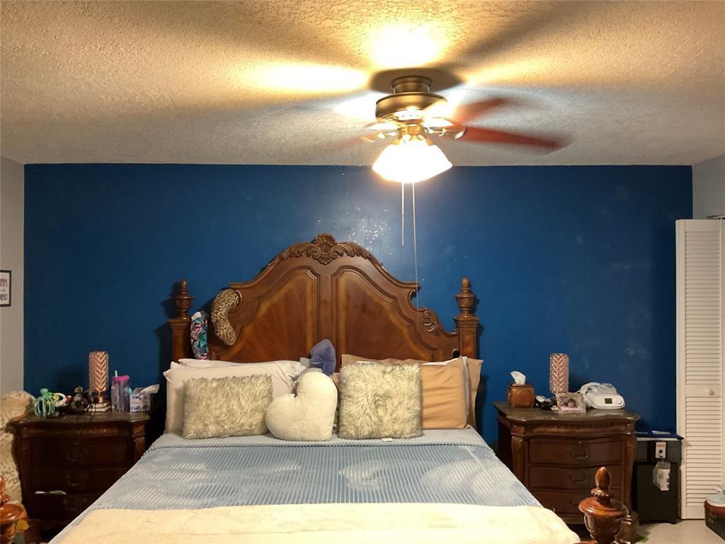 4770 Northwest 85th Avenue Lauderhill, FL 33351 - Photo 17 of 44 a bedroom with a bed and a chandelier